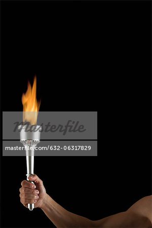 Man's hand holding torch with no flame, cropped
