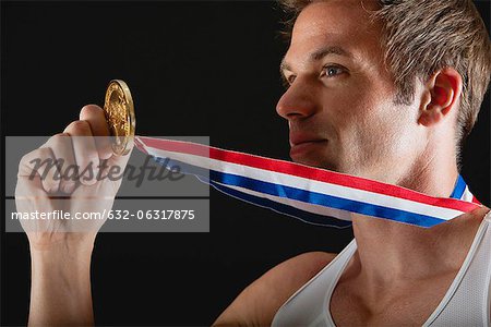 Athlete holding gold medal