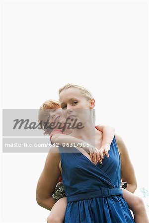 Boy riding on mother's back