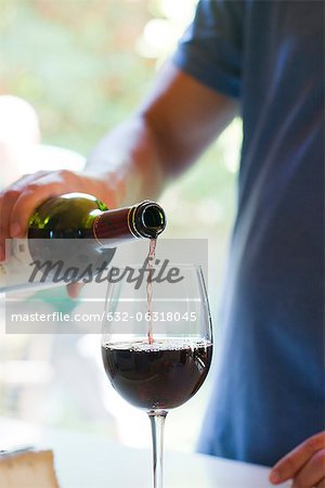 Man pouring glass of red wine