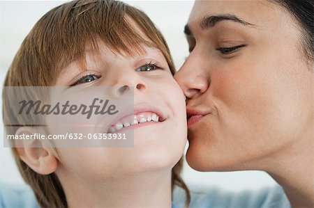 Mother kissing boy's cheek