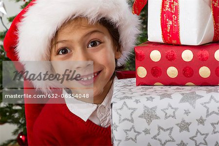 Boy with stack of Christmas presents, portrait