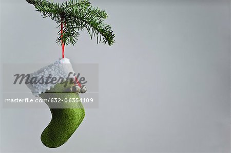Christmas stocking ornament hanging on branch
