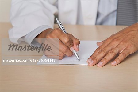 Doctor writing prescription, cropped