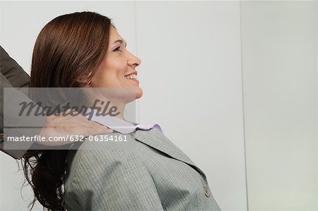 Mature businesswoman having her shoulders massaged