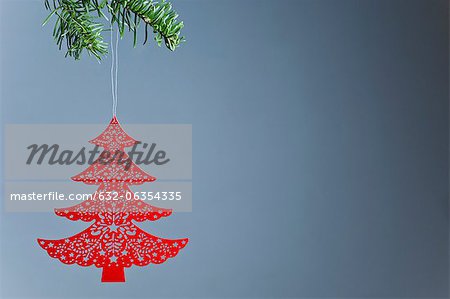 Christmas tree ornament hanging on branch, off center