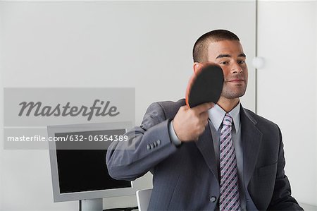 Young man playing table tennis in office