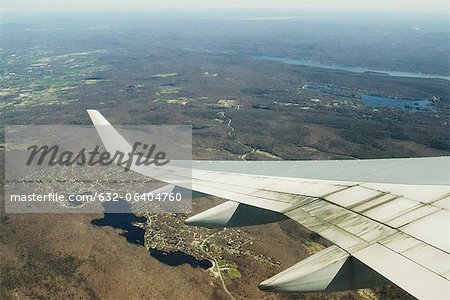 Focus on an airplane wing, flying united states