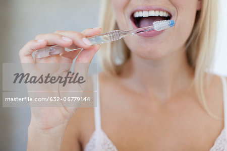 Woman brushing her teeth, cropped
