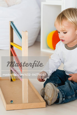 Baby playing with marble rolling game