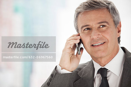 Business executive using cell phone, portrait
