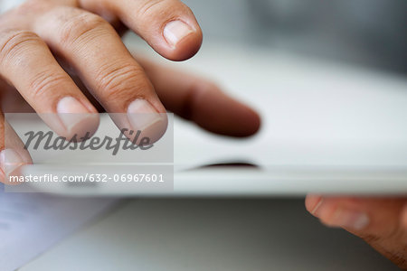 Man using touch screen on digital tablet, cropped