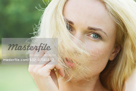 Woman covering face with hair, portrait