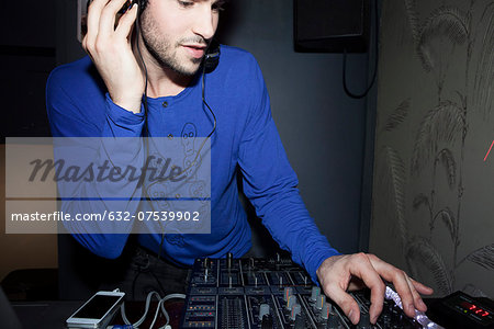 DJ using audio mixer DJ using audio mixer