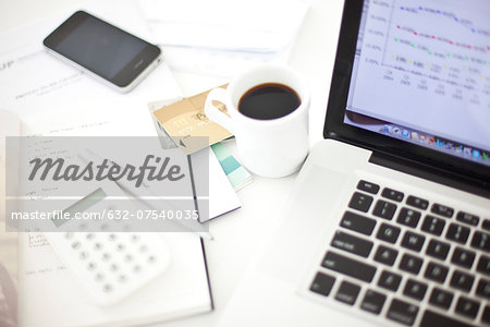 Credit cards resting near laptop computer in home office