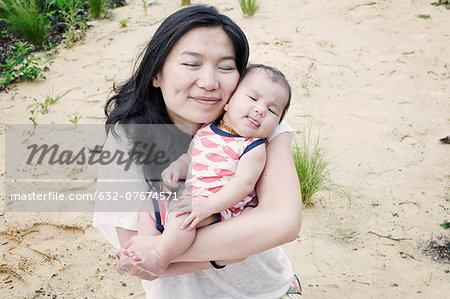 Mother with infant son outdoors, portrait