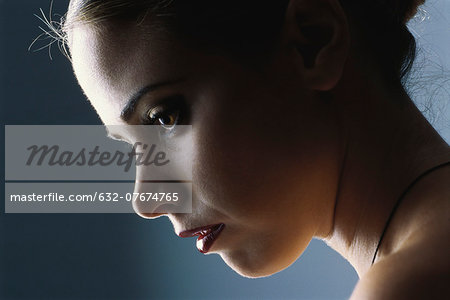 Woman looking down, profile, close-up