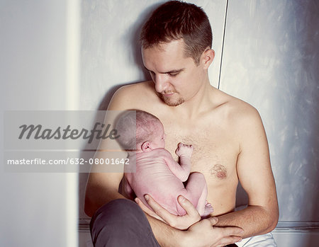 Father holding newborn baby