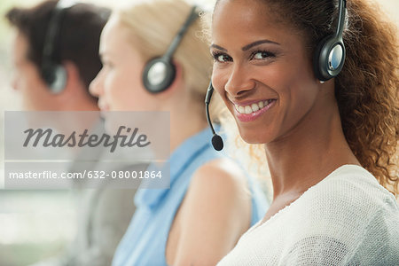 Woman working in call center, smiling cheerfully