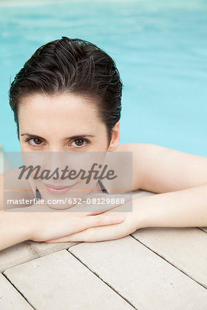 Woman relaxing in pool, portrait