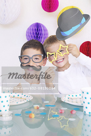 Boys wearing funny disguises at birthday party