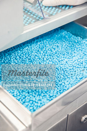 Compartment full of pills in industrial packaging equipment
