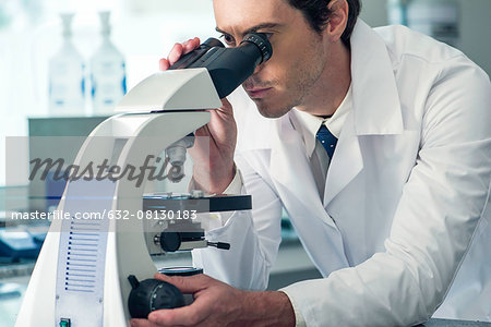 Biologist using microscope