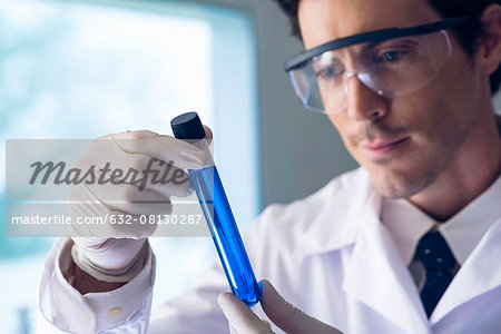 Scientist examining test tube