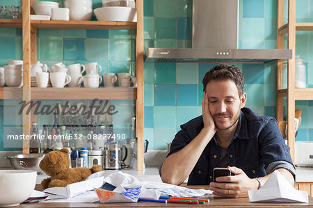 Man at home using smartphone