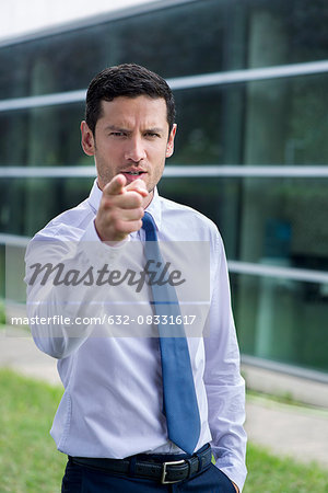Businessman pointing finger in accusation Businessman pointing finger in accusation