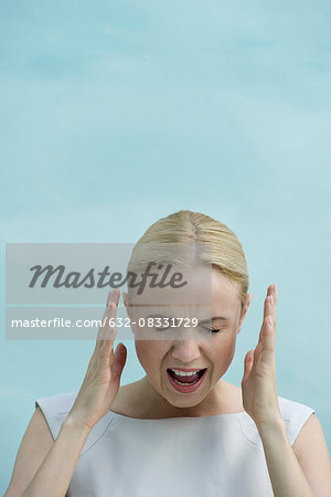 Woman shouting with eyes closed