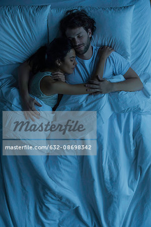 Couple asleep embracing