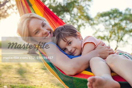 Mother and son relaxing in hammock together