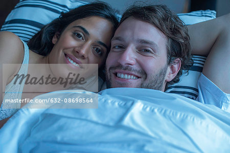 Couple in bed together, portrait