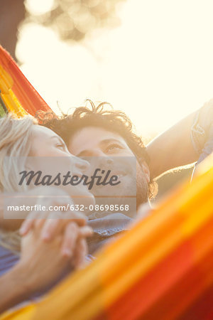 Couple relaxing together in hammock