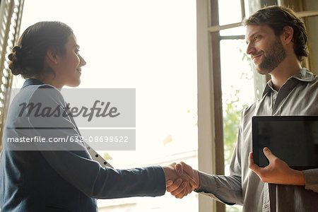 Insurance agent shaking hands with prospective client