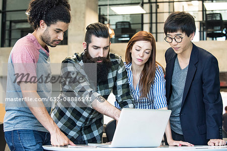 Colleagues working together with laptop computer