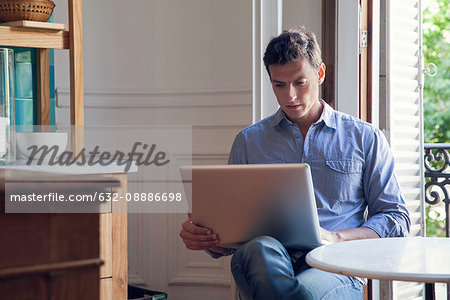 Man using laptop computer at home