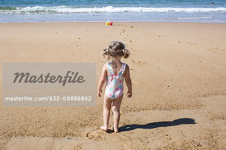 Little girl at the beach, rear view - Stock Photo - Masterfile - Premium
