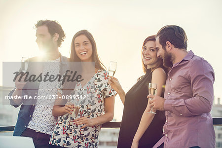 Group of friends relaxing with wine outdoors