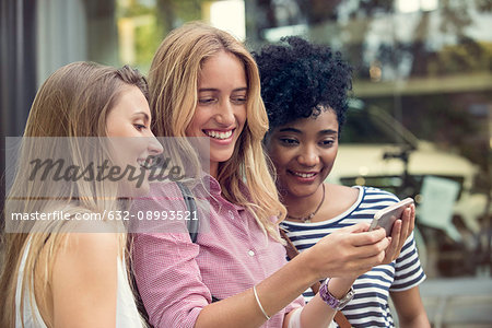 Friends using smartphone to take a selfie