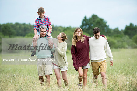 Family strolling together in field