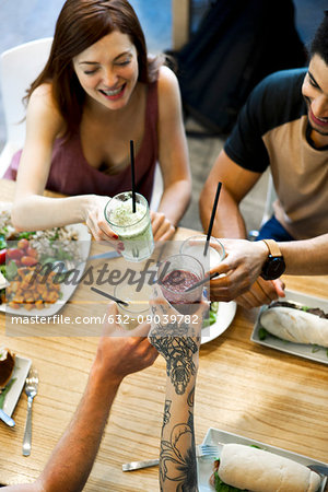 Friends clinking glasses in restaurant