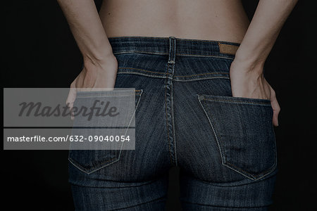 Woman wearing jeans, hands in back pockets