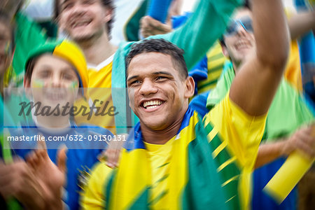 Brazilian football fans cheering at football match