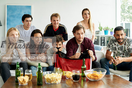 German football fans watching football match at home