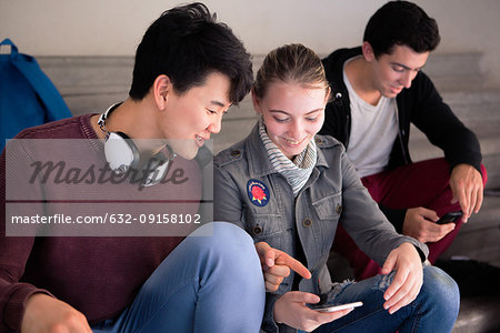 Friends looking at smartphone together