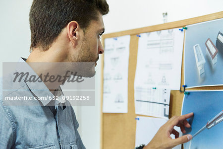 Engineer looking at notice board