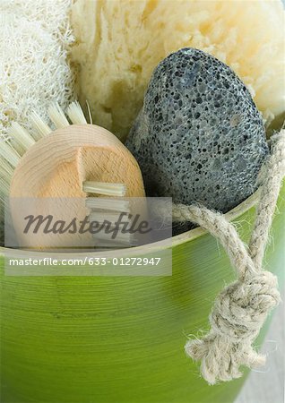 Bowl containing bath sponges, brush and pumice stone