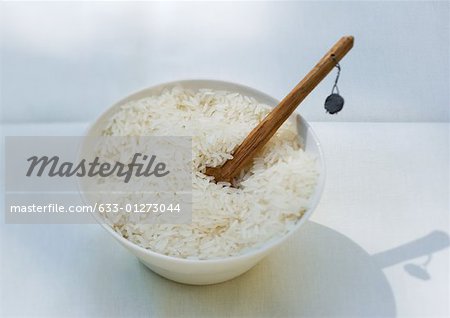 Bowl of rice and wooden spoon